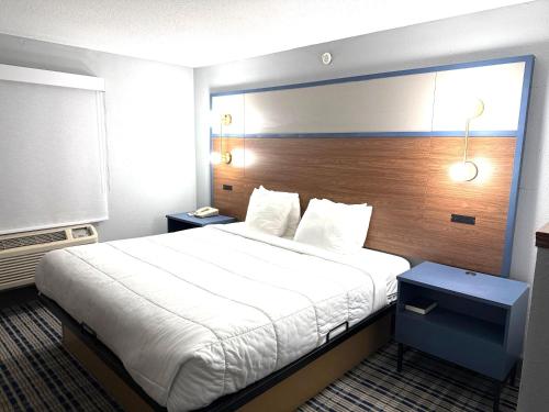 a hotel room with a large bed in a room at AmericInn by Wyndham Frankfort IN in Frankfort