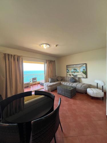 a living room with a couch and a table at 2BR Sea View Chalet Porto sokhna in Ain Sokhna