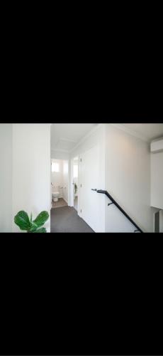 a room with white walls and a plant in it at Otatara Bush Haven in Otatara
