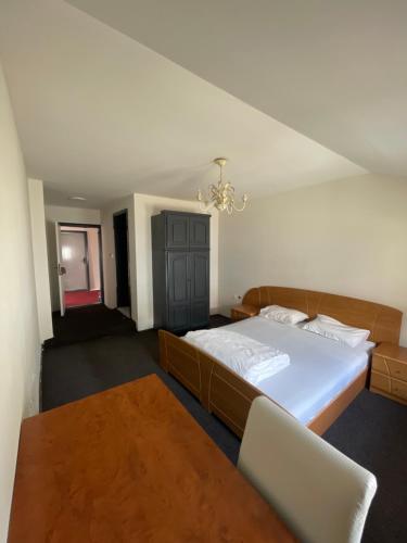 a bedroom with a large bed and a table at Hostel 8 in Prishtinë