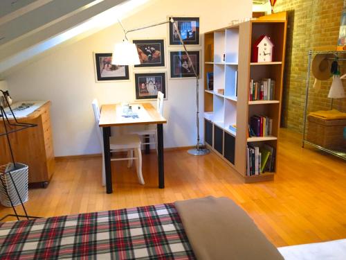 a room with a table and a book shelf at La Mansarda di Margherita in Treviso