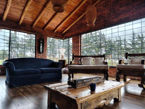 a living room with a couch and a coffee table at La Toscana, Chalet Campestre in Guasca