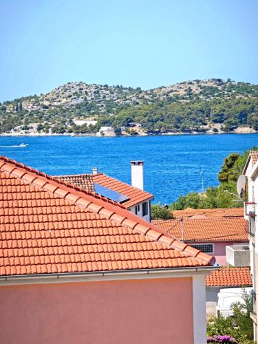 a view of the ocean from the roofs of buildings at Providenca Residence Šibenik in Šibenik