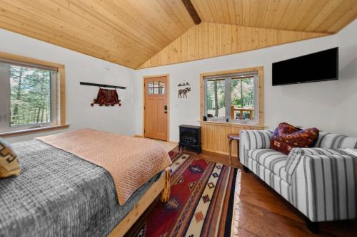 a bedroom with a bed and a couch at Moose Hollow Studio Cabin in Eureka