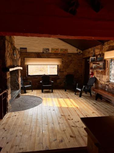 a large room with chairs and a window in a building at Refugio Pehuenche in Los Molles