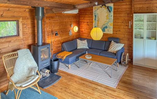 a living room with a couch and a stove at Cozy Home In Ebeltoft With Wifi in Ebeltoft