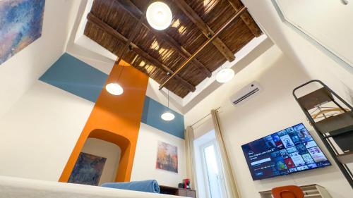a room with a vaulted ceiling and a mirror at Diso apartments in Naples