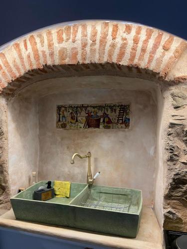 a bathroom with a sink in a stone wall at Περιβόλι του Οδυσσέα in Volissos