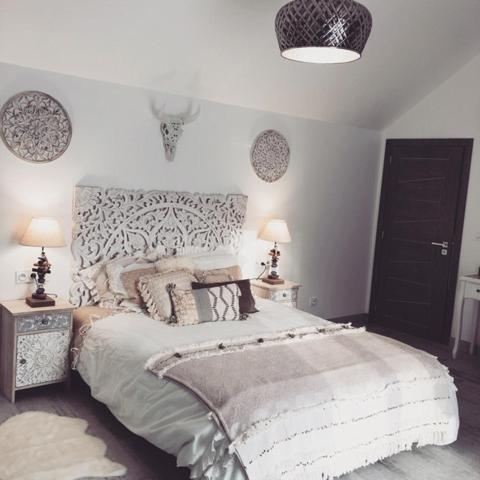 a bedroom with a large bed and two tables with lamps at Villa Champlan in Champlan
