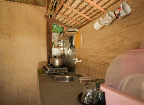 a kitchen with a sink and a counter top at Kabilin Homestay in General Luna
