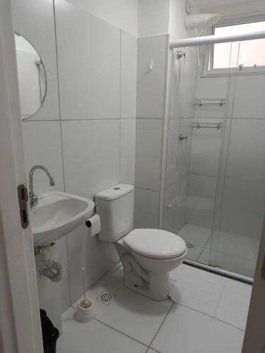 a white bathroom with a toilet and a shower at Lar Luar do Sertão in Aracaju
