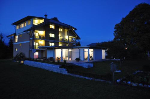 a large house with its lights on at night at Karglhof Stammhaus in Faak am See