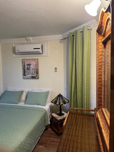 a bedroom with a bed and a lamp on a table at Seaside Escape in Montego Bay