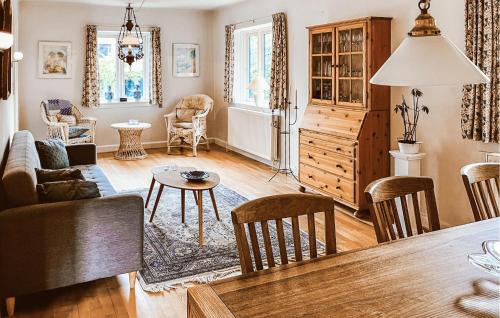 a living room with a table and chairs at 2 Bedroom Nice Home In Hundested in Hundested