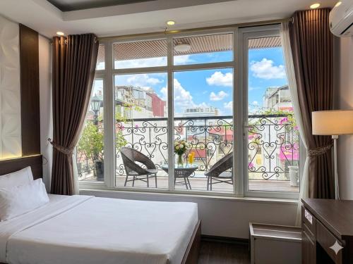 a bedroom with a bed and a large window at Hanoi Diamond King Hotel & Travel in Hanoi