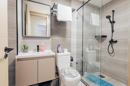 a bathroom with a shower and a toilet and a sink at Everlett Lavington Homes in Nairobi