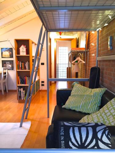 a living room with a loft bed and a couch at La Mansarda di Margherita in Treviso