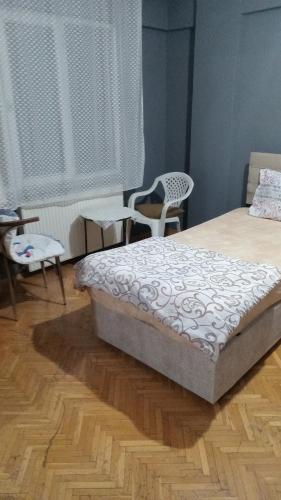 a bedroom with a bed and two chairs in it at Huzur 30 in Edirne