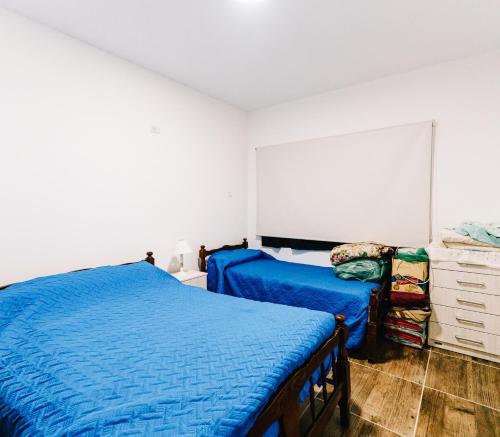 a bedroom with two beds and a dresser at Casa Las Dunas in Monte Hermoso