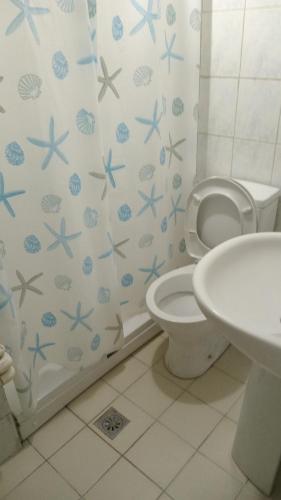 a bathroom with a white toilet and a sink at Huzur 30 in Edirne