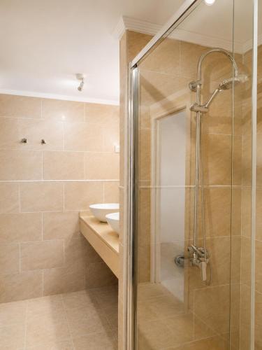 a bathroom with a shower and a sink at Nogalera Sea View Luxe in Torremolinos