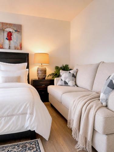 a living room with two beds and a couch at Oceanfront Escape with Private Bath and Beach Access in Gibsons