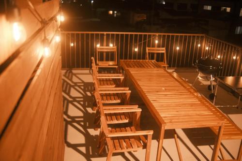 a row of tables and chairs in a room with lights at Private Stay EN SUMOTO in Sumoto