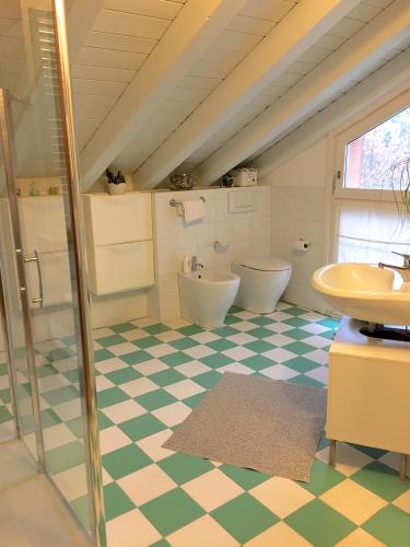 a bathroom with two toilets and a sink at La Mansarda di Margherita in Treviso
