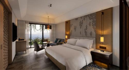 a bedroom with a large bed and a living room at Manado Marriott Resort & Spa in Manado