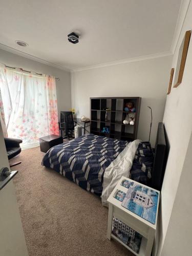 a bedroom with a bed and a tv in it at Cozy and comfortable room - Geelong suburbs in Grovedale