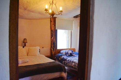 a bedroom with a mirror with a bed and a window at San Pedro in Ráquira