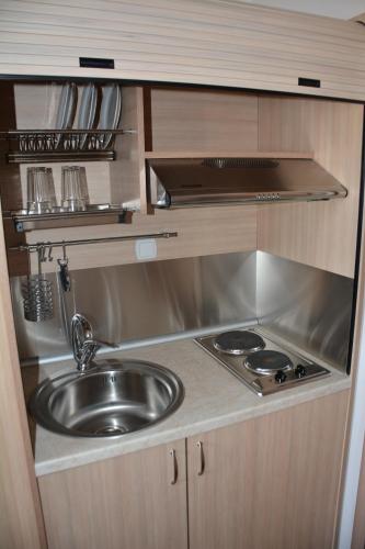 a kitchen with a sink and a stove at City Point Chios in Chios