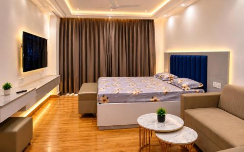 a bedroom with a bed and a living room at Craviq Hotels -1 in Ghaziabad