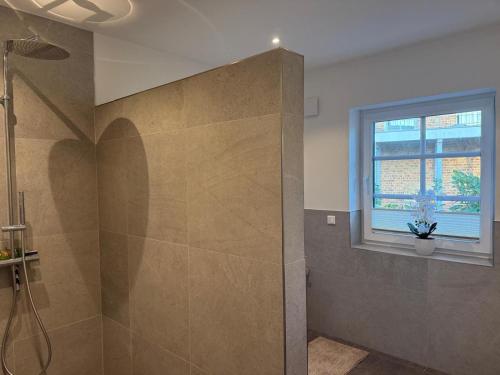 a bathroom with a shower and a window at Grodehus-Eigener-Bungalow in Haby