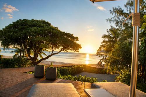a view of the beach and the ocean at sunset at Aitutaki Escape Resort & Spa in Arutanga