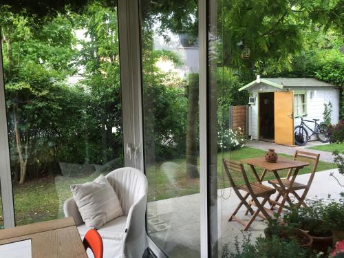 a screened in porch with a table and chairs at La Mansarda di Margherita in Treviso