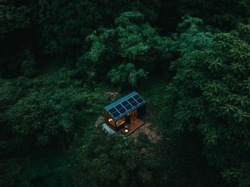an overhead view of a house in the middle of a forest at awake Gojome in Akita