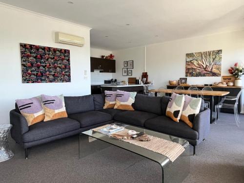 a living room with a couch and a table at Jasper 3 in Jindabyne