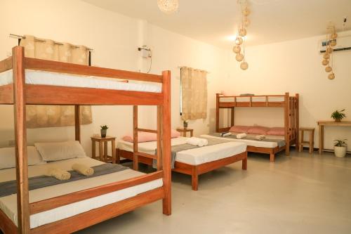 a bedroom with three bunk beds in a room at Kabilin Homestay in General Luna