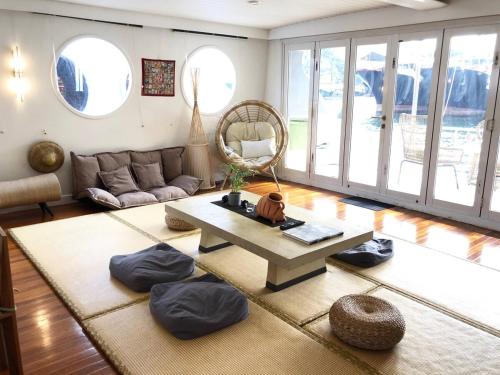 a living room with a couch and a table at Cipango - Hong Kong Houseboat in Hong Kong