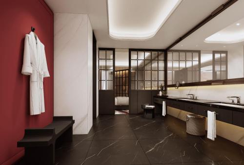 a bathroom with a sink and a red wall at Mövenpick Kaifeng West Lake in Kaifeng