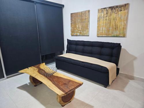 a bedroom with a bed and a couch and a table at Playa y Luna in Progreso