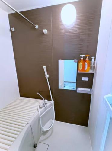 a small bathroom with a toilet and a sink at The Scene Fuchinobe in Sagamihara