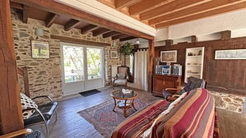 a living room with a couch and a table at L'humeur vagabonde in Linards
