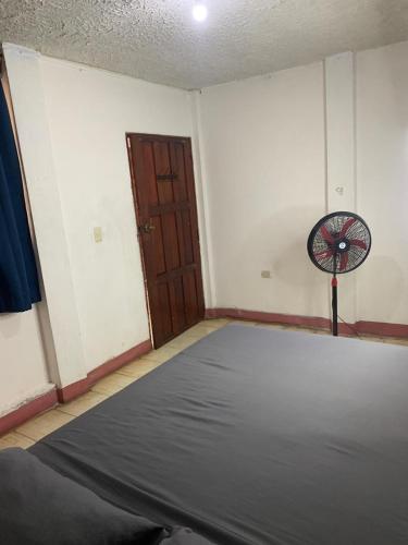 a room with a bed and a fan in it at Casa Volcán Granada in Granada