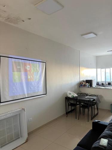 a living room with a large projection screen on the wall at Casa próx senai e quartel in Três Lagoas