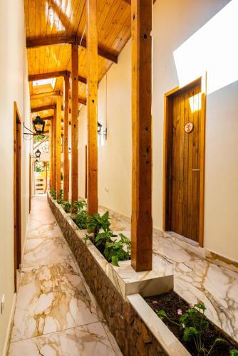 a hallway with a stone floor and wooden beams at Hotel Dorys de Lourdes in Pisco Elqui
