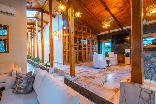a living room with couches and tables in a building at Hotel Dorys de Lourdes in Pisco Elqui