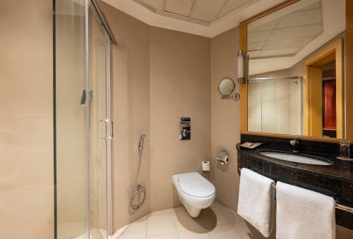 a bathroom with a toilet and a sink and a shower at Ibis Riyadh Hotel Al Muhammadiyah United Company Branch in Riyadh