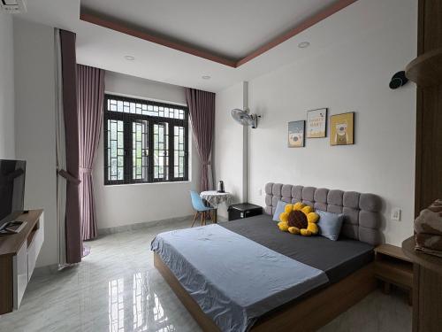 a bedroom with a bed with a stuffed animal on it at The Sweet Home in Nha Trang